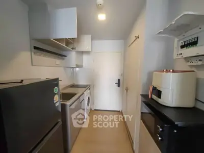 Compact kitchen with modern appliances and efficient storage solutions