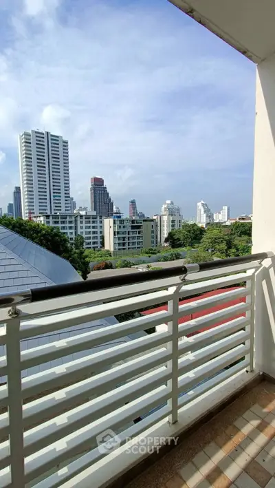 Stunning cityscape view from a modern balcony with sleek railing design.