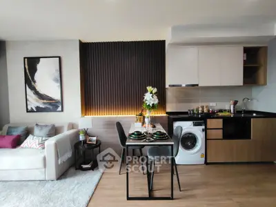 Modern open-plan living room with stylish kitchen and washing machine