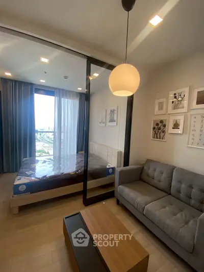 Modern studio apartment with stylish decor and city view, featuring a cozy living area and comfortable bedroom.