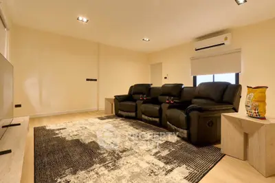 Spacious living room with cozy leather seating and modern decor