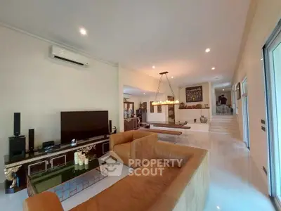 Spacious living room with modern decor and elegant lighting