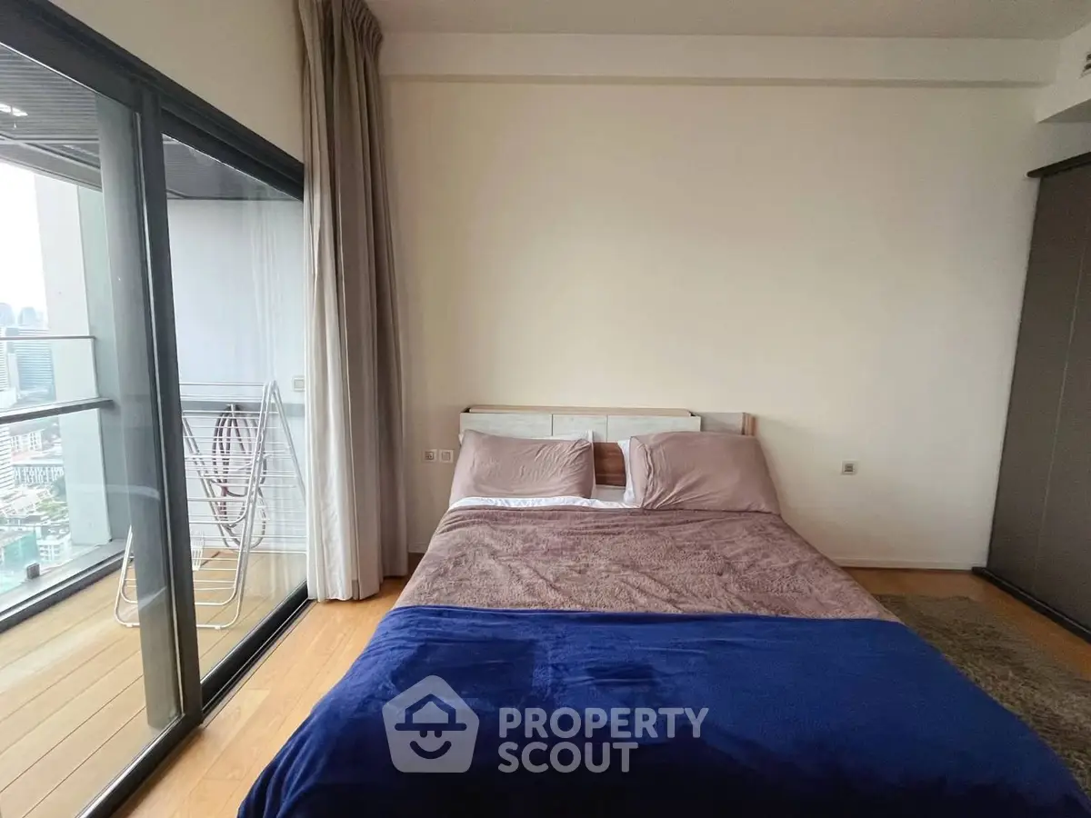 Modern bedroom with balcony view in high-rise apartment