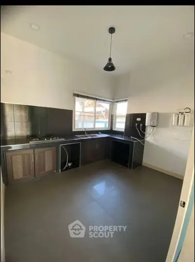 Modern kitchen with sleek black countertops and gas stove