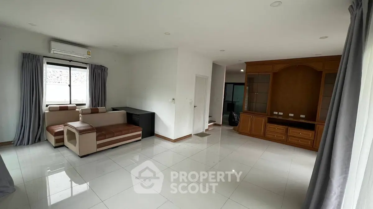 Spacious living room with modern furniture and large windows for natural light.