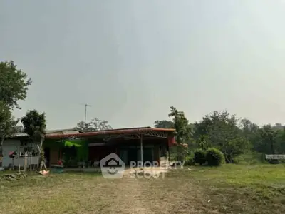 Charming rural property with spacious outdoor area and lush greenery