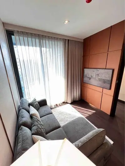 Luxurious living room with modern decor and large window offering natural light.