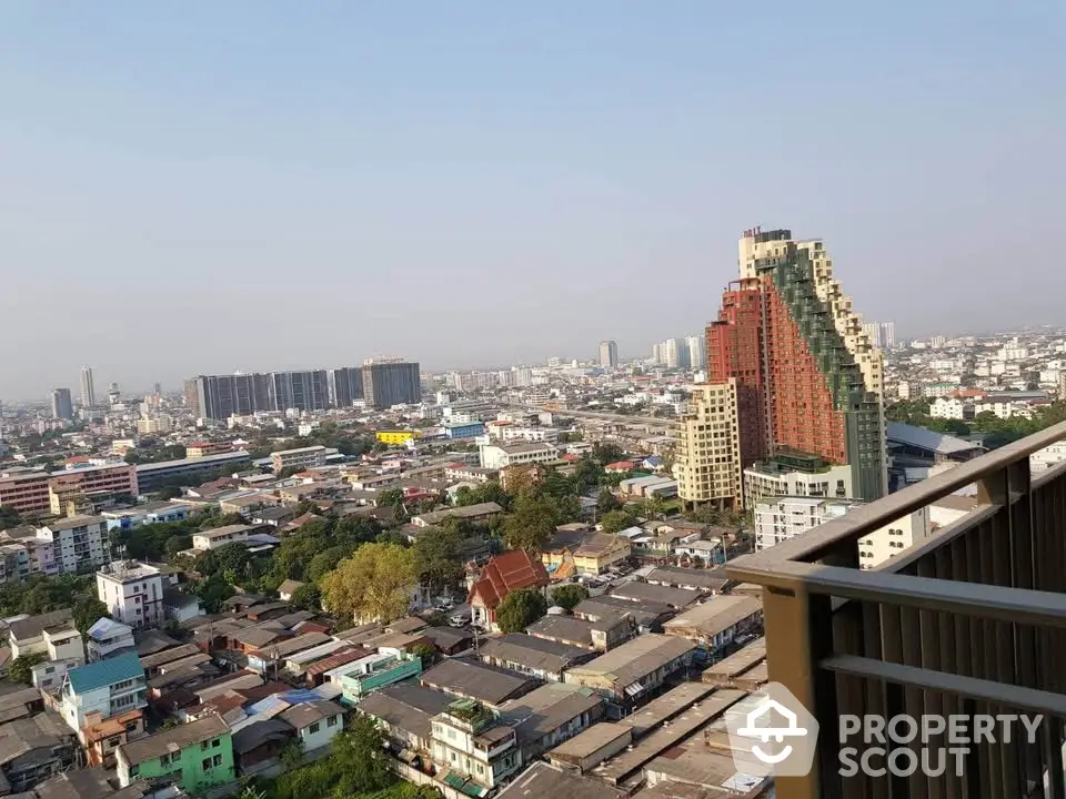 Stunning cityscape view from high-rise balcony showcasing urban skyline and architectural diversity.