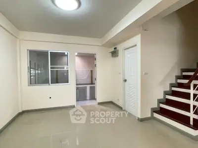Spacious interior with staircase and tiled flooring, ideal for modern living.