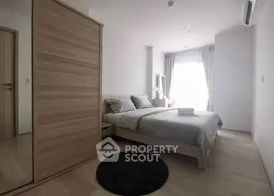 Spacious bedroom with modern furnishings and natural light