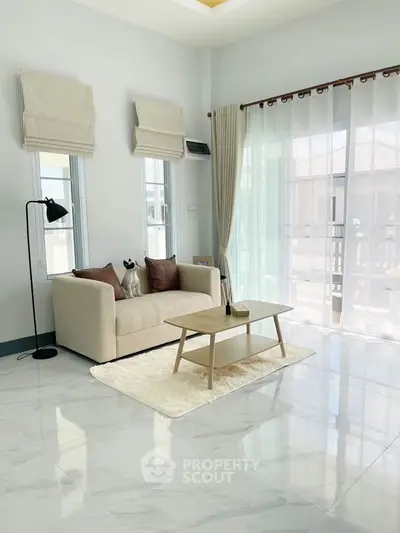 Bright and airy living room with modern decor and large windows.