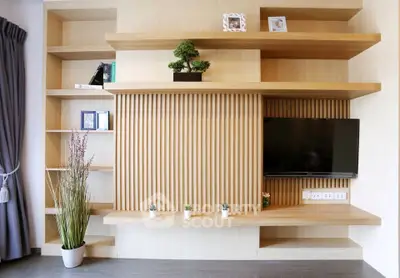 Modern living room with stylish wooden shelving and mounted TV, perfect for contemporary home decor.