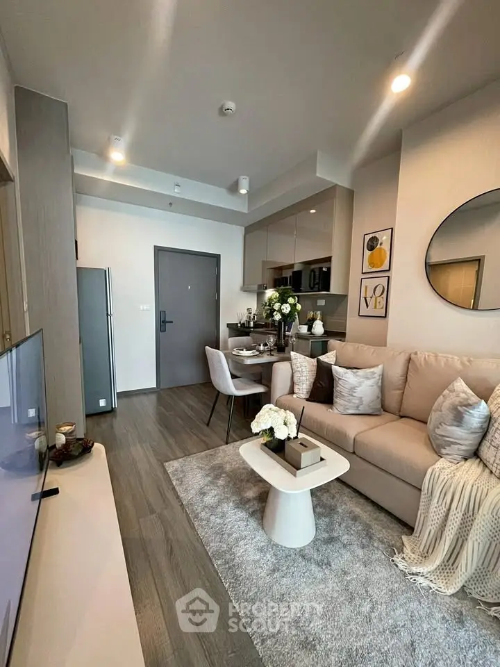 Modern living room with stylish decor and open kitchen layout in a cozy apartment.