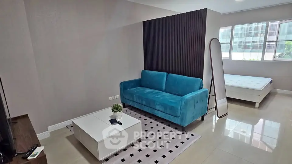 Modern living room with blue sofa and stylish decor in a bright apartment