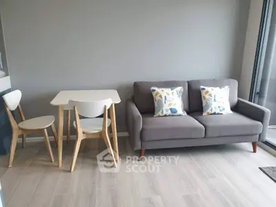 Modern living room with cozy gray sofa and stylish dining set