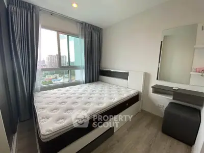 Modern bedroom with city view, featuring a comfortable bed and stylish decor.