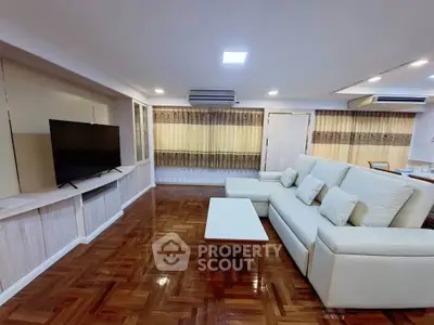 Spacious living room with elegant parquet flooring and modern furnishings
