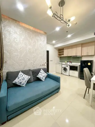 Modern living room with stylish kitchen and cozy sofa in open layout apartment.