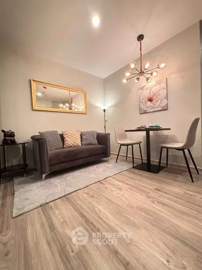 Stylish living room with modern decor and elegant lighting in a cozy apartment setting.