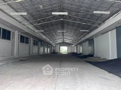 Spacious industrial warehouse with high ceilings and ample storage space.