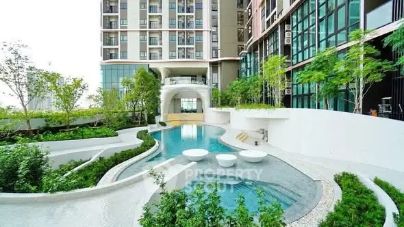 Luxurious modern apartment complex with stunning pool and lush greenery