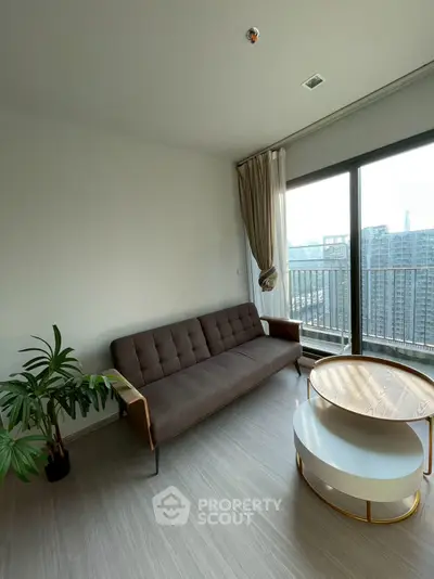 Modern living room with stylish sofa and balcony view in high-rise apartment