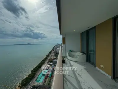 Stunning high-rise balcony with ocean view and luxurious jacuzzi.
