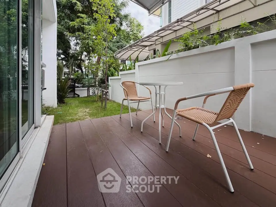 Charming outdoor patio with seating area in a modern residential setting.