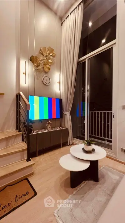 Modern living room with high ceilings, stylish decor, and a cozy seating area.