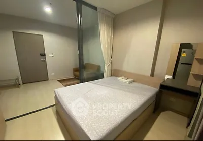 Modern bedroom with cozy bed and sliding glass partition in stylish apartment