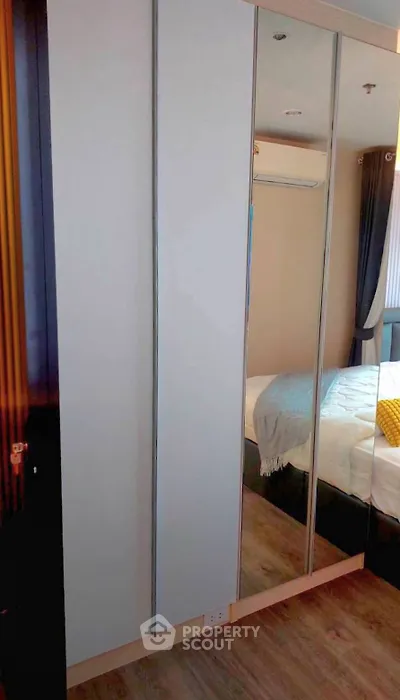 Modern bedroom with mirrored wardrobe and cozy bedding