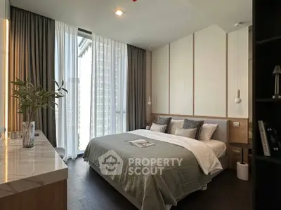 Luxurious modern bedroom with elegant decor and large window view in high-rise apartment.