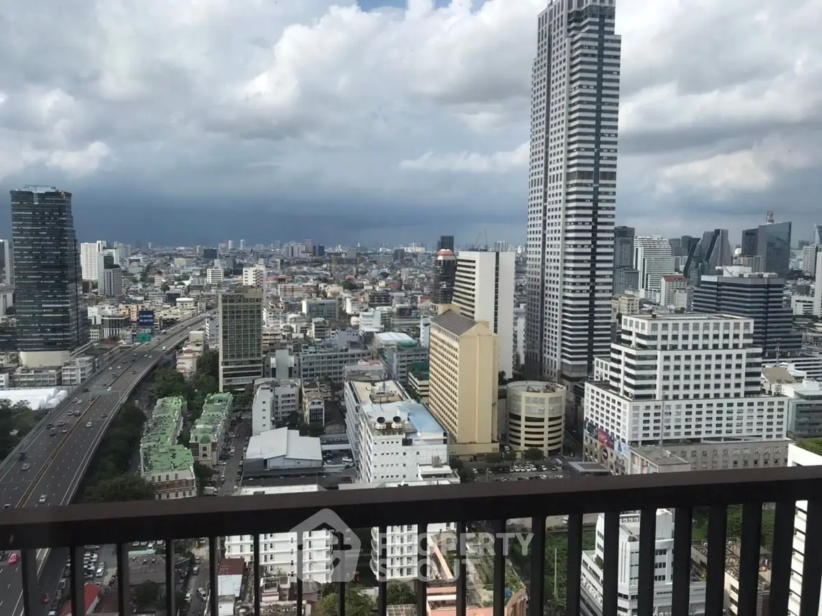 Stunning cityscape view from a high-rise balcony showcasing urban skyline and modern architecture.