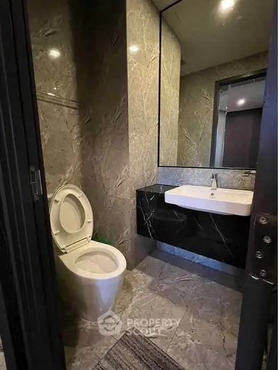 Luxurious modern bathroom with marble walls and sleek fixtures