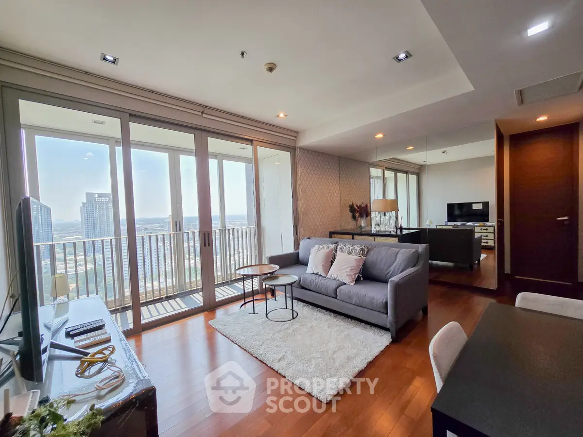 Spacious modern living room with balcony view in high-rise apartment