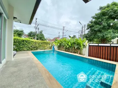 Stunning private pool with lush greenery in a serene residential setting.