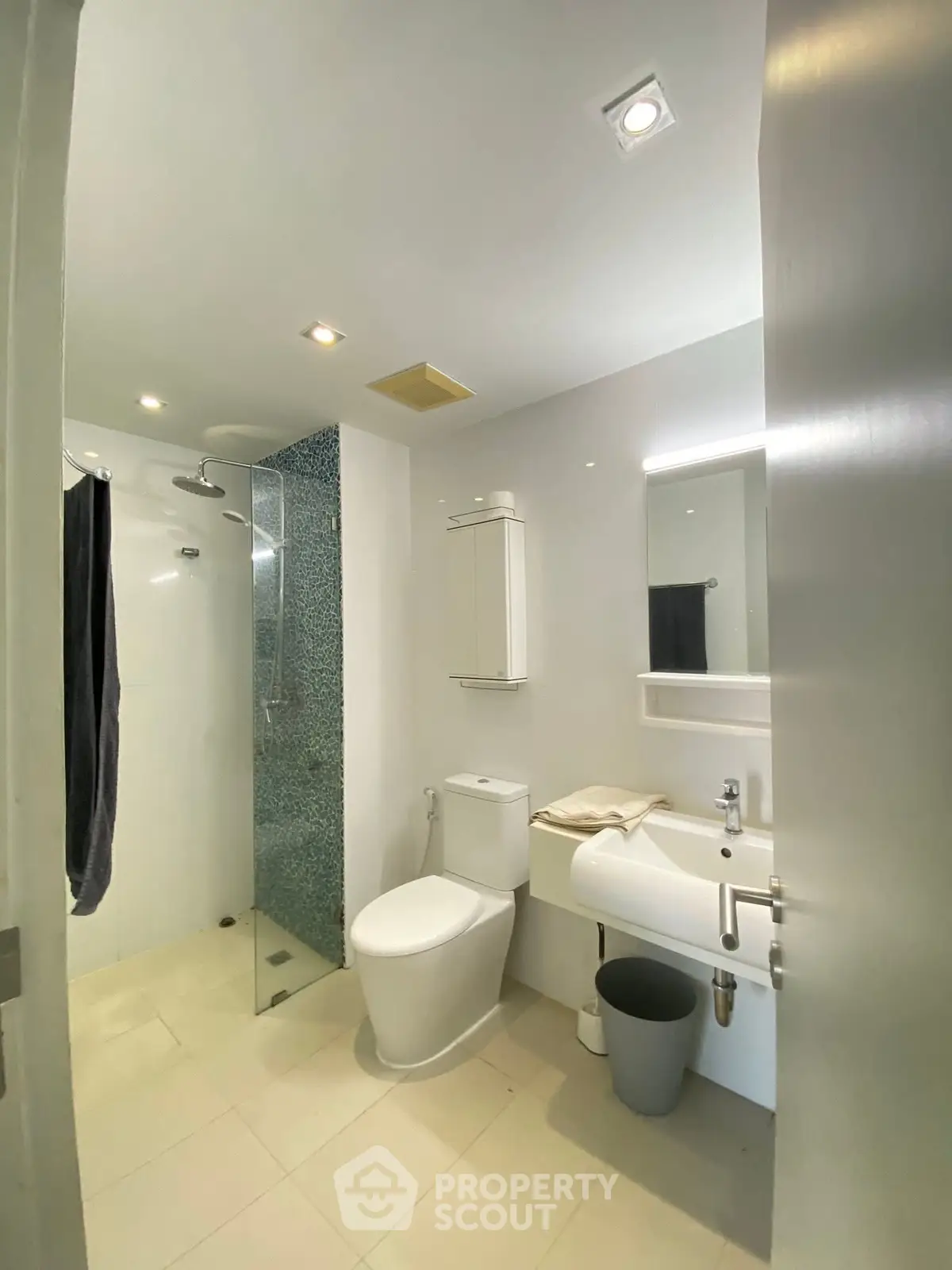Modern bathroom with sleek fixtures and glass shower in a bright, minimalist design.