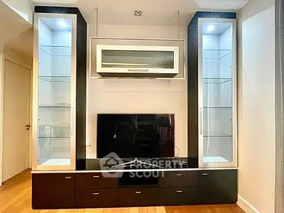 Modern living room with sleek entertainment center and glass display cabinets