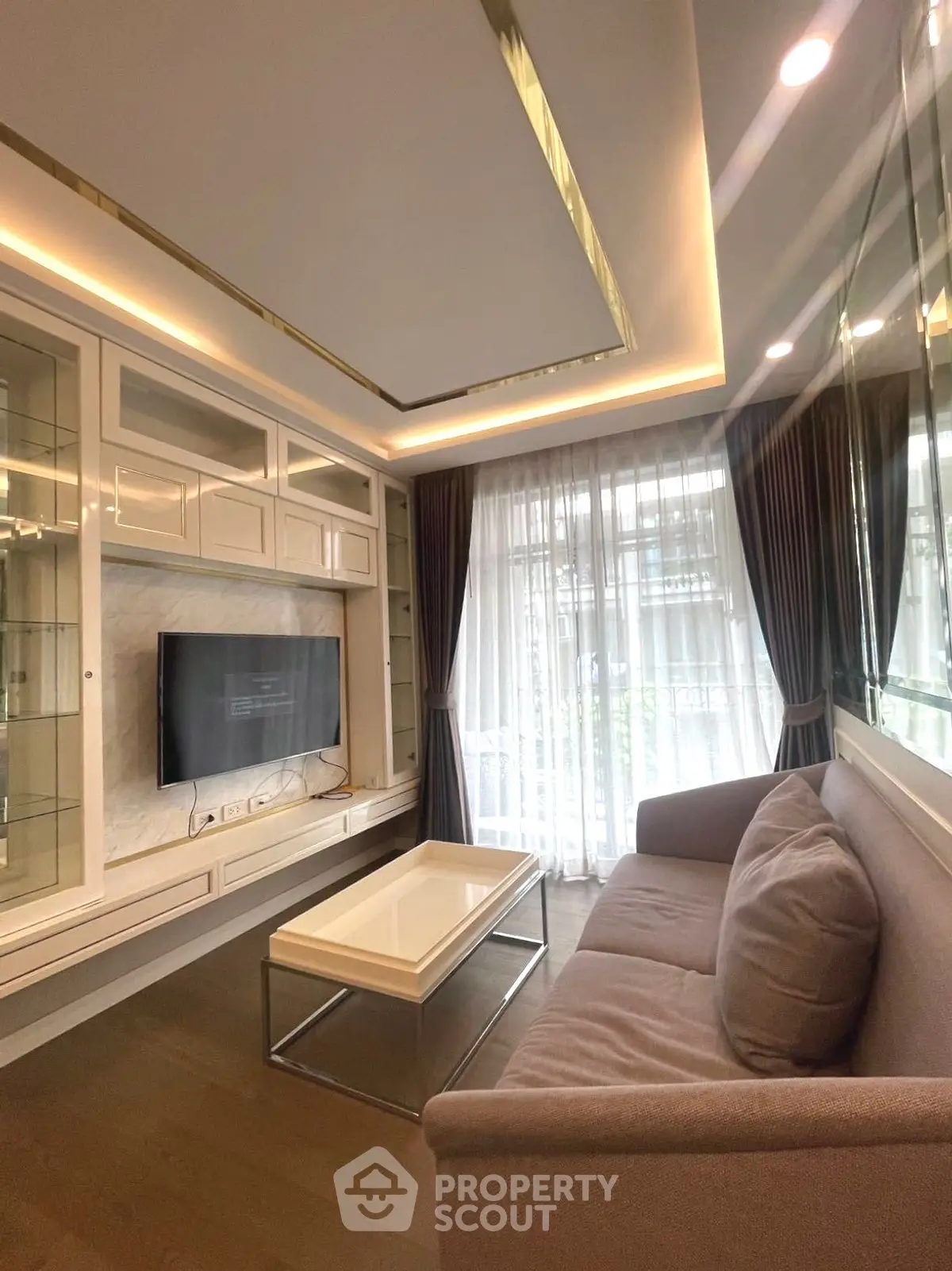 Modern living room with sleek design, large windows, and stylish furniture.