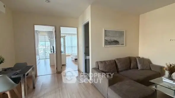 Spacious living room with modern decor and natural light in a stylish apartment.