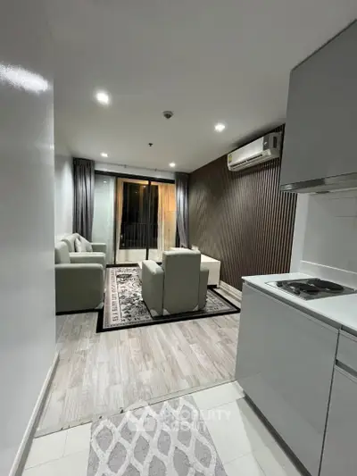 Modern living room with open kitchen and balcony view