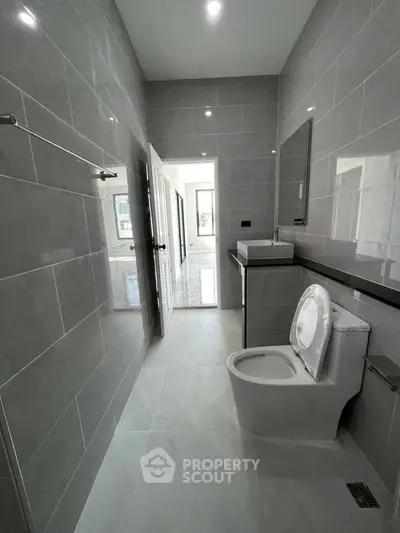Modern bathroom with sleek gray tiles and contemporary fixtures