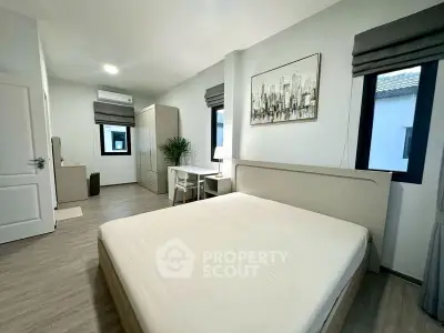 Spacious modern bedroom with minimalist decor and natural light