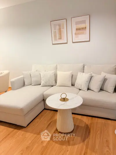 Elegant living room with modern white sectional sofa and stylish decor