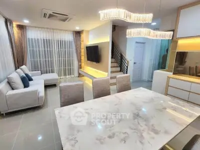 Modern open-plan living room with elegant lighting and stylish furniture