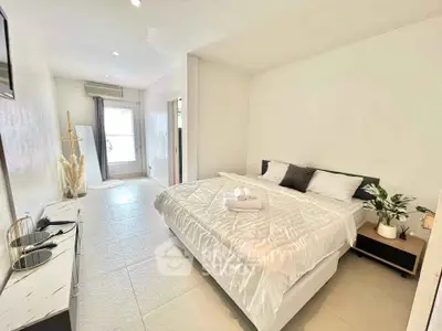 Spacious modern bedroom with elegant decor and natural light