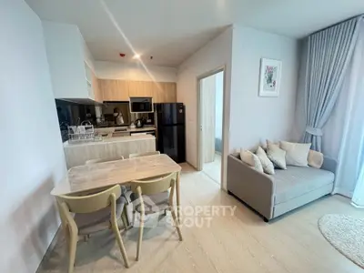 Modern open-plan kitchen and living area with stylish decor and natural light.