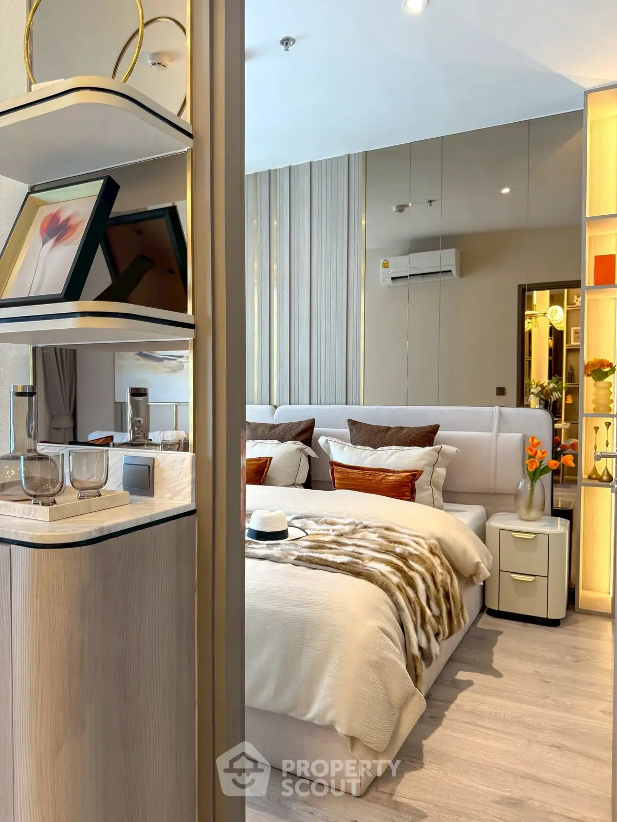 Luxurious modern bedroom with elegant decor and plush bedding in a stylish apartment.