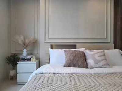 Elegant bedroom with cozy bedding and stylish decor, perfect for relaxation and comfort.