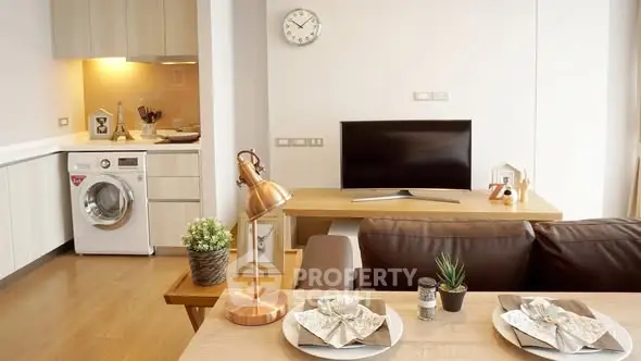 Modern living room with open kitchen and washing machine, stylish decor